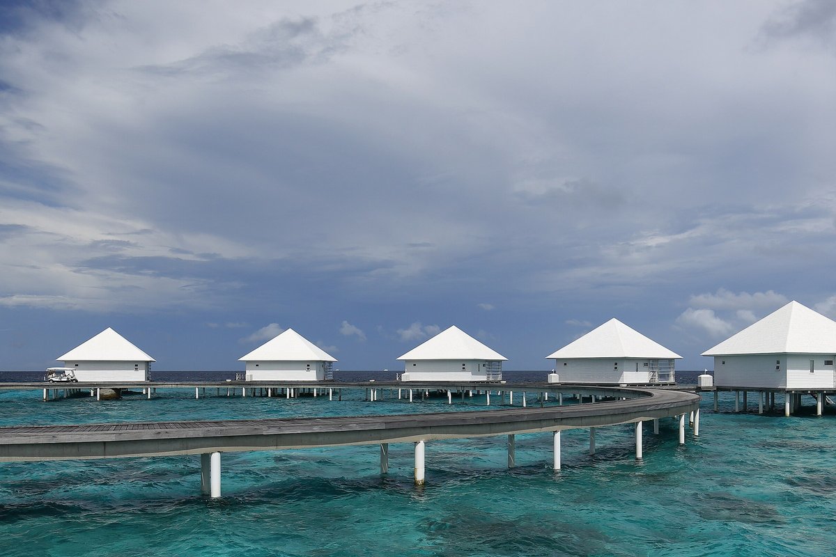 Overwater villas above a turquoise Maldives lagoon